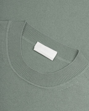 Sage green knitted sweater neckline close-up
