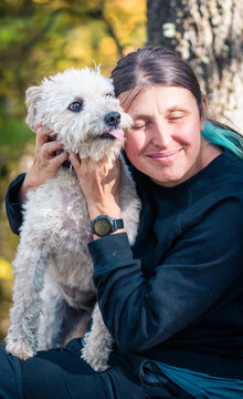 happy woman with dog enjoying autumn outdoors