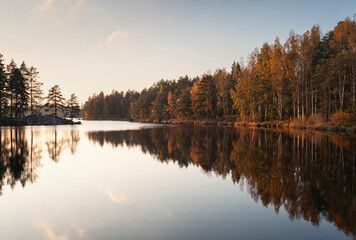 Scenic landscape of autumn trees by lake © FOLIO
