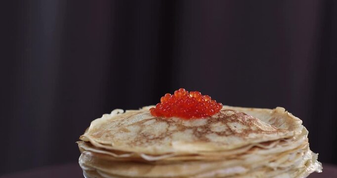 lots of delicious, mouth-watering pancakes with red caviar for Russian Maslenitsa
