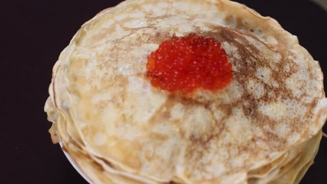 lots of delicious, mouth-watering pancakes with red caviar for Russian Maslenitsa
