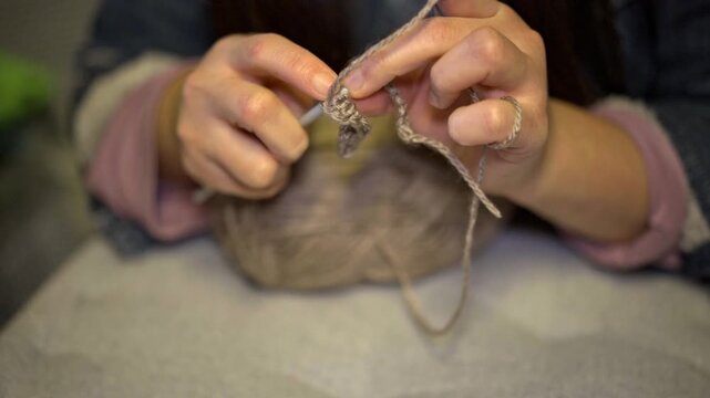 Woman Crocheting with Hook and Yarn Close-Up