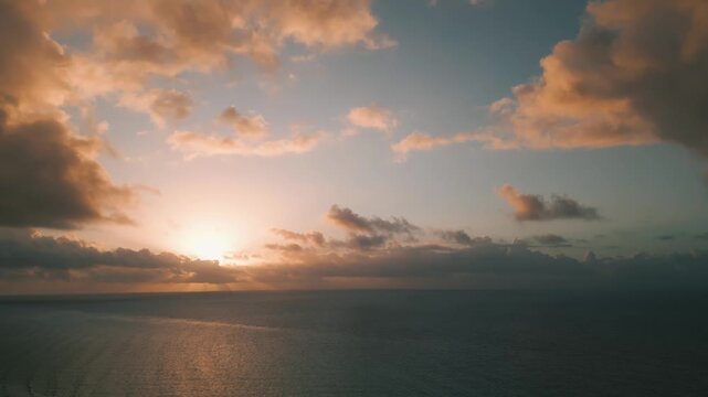 Warm dusk light spreading across a tranquil open ocean horizon