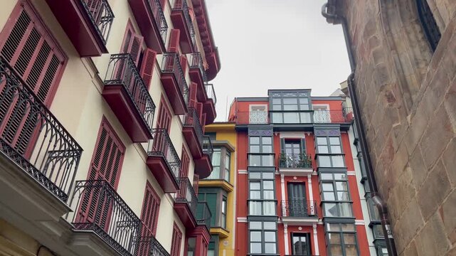 Colorful historic buildings with traditional balconies and wooden shutters in Casco Viejo, the old town of Bilbao, Spain