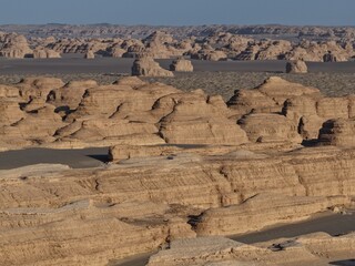 Yadan National Geopark near Dunhuang, Gansu, China, features dramatic wind-eroded rock formations rising from the Gobi Desert. A striking landscape along the ancient Silk Road. © JEREMIE