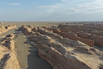 Yadan National Geopark near Dunhuang, Gansu, China, features dramatic wind-eroded rock formations rising from the Gobi Desert. A striking landscape along the ancient Silk Road. © JEREMIE