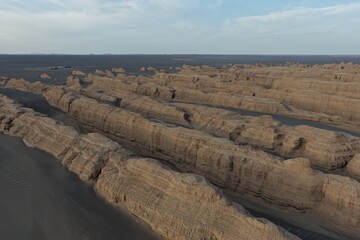 Yadan National Geopark near Dunhuang, Gansu, China, features dramatic wind-eroded rock formations rising from the Gobi Desert. A striking landscape along the ancient Silk Road. © JEREMIE