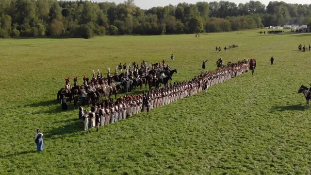 Gentle aerial along formed ranks and riders