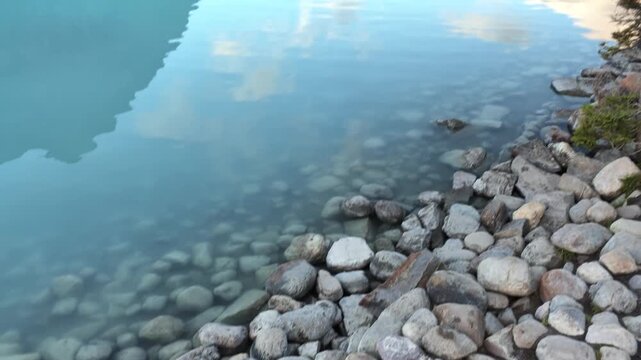 aerial view of Girl traveler enjoying peaceful Lake Louise reflecting in Banff National Park, Alberta, Canada. Summer vacation, travel lifestyle, outdoor adventure, nature wellness sightseeing