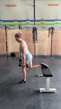 woman doing Bulgarian Split Squats in gym