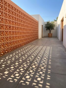 Terracotta Brick Perforated Screen Wall With Geometric Shadows
