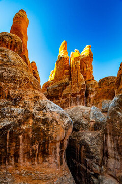 Fiery Furnace glows with golden sunrise light in Utah