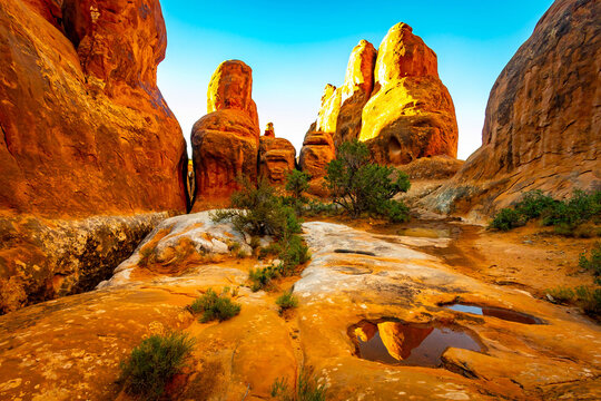 Fiery Furnace glows with golden sunrise light in Utah
