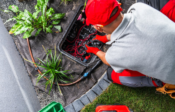 Technician servicing a garden irrigation valve box