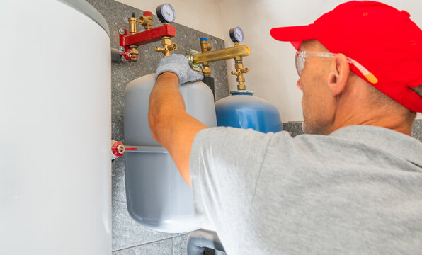 Technician checking an expansion vessel connection