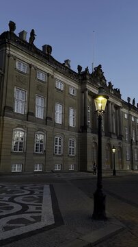 Copenhagen, Denmark -1.09.2026: View of the Amalienborg Square with a female royal guard, Royal Life Guard, standing in front of the Levetzau's Palace. Traditional Danish architecture. Royal residence