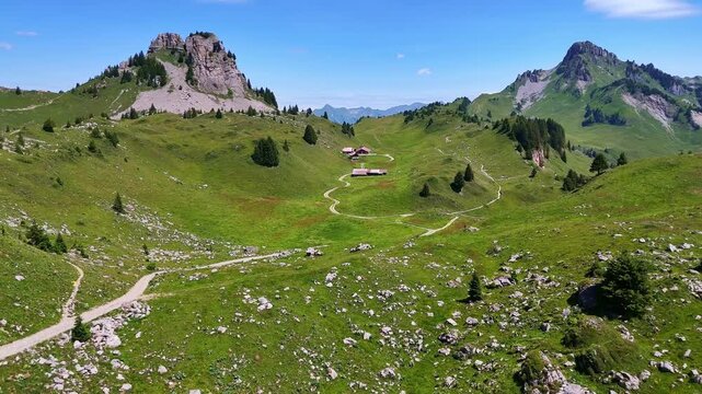 Red cogwheel railway train in Swiss Alps. Schynige Platte mountain near Interlaken. Switzerland summer tourism hiking destination. 