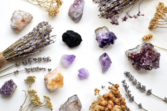 Beautiful natural amethyst, citrine, and schorl tourmaline crystals, and dried herbs. Healing crystals. Divination and magic.