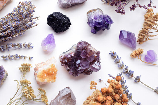 Beautiful natural amethyst, citrine, and schorl tourmaline crystals, and dried herbs. Healing crystals. Divination and magic.