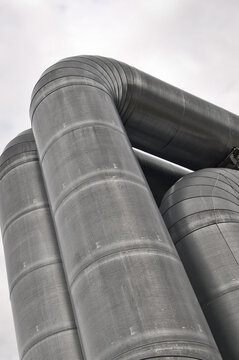 close-up of a pipeline against a gray sky
