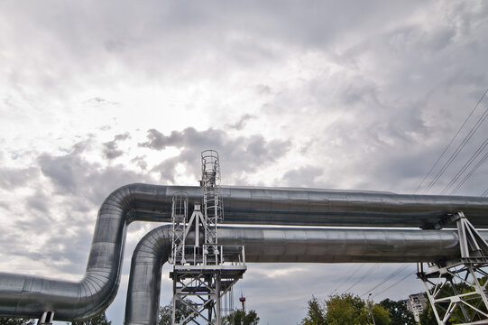 The photo shows a pipeline against a gray sk