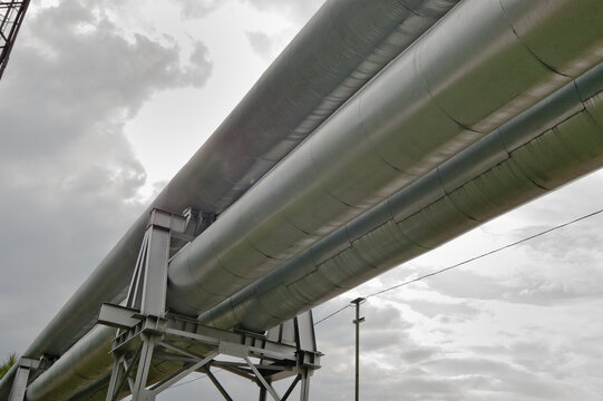 The photo shows a pipeline against a gray sk