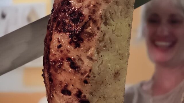 Juicy pineapple slices, grilled with a caramelized cinnamon coating, being carved from a traditional skewer, offering sweet and flavorful dessert experience at Brazilian steakhouse. luxury lifestyle.