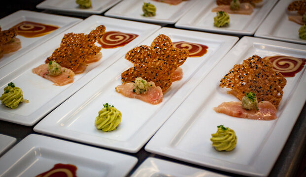 Gourmet Fish Crudo Platters with Swirled Sauce and Sesame Tuile