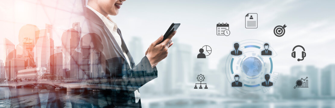 A business professional engages with a smartphone, surrounded by digital icons, representing modern communication and strategic planning in a vibrant urban environment. Nascent