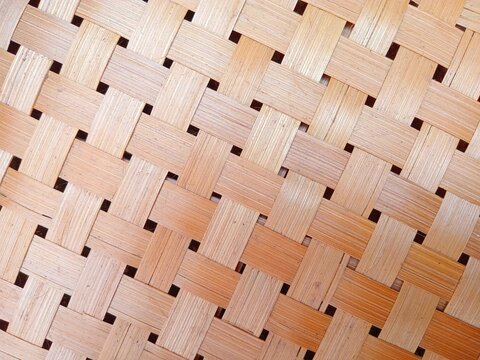 Woven walls of thin bamboo slabs. Made manually by hand. Bamboo pattern background. Bamboo weaving.