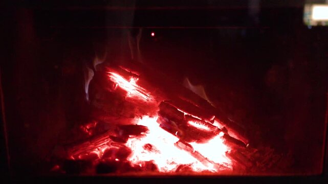 Glowing Red Embers and Fireplace Logs Burning Slowly