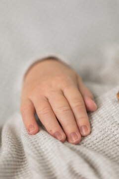 Closeup of a newborn infant baby hand while sleeping