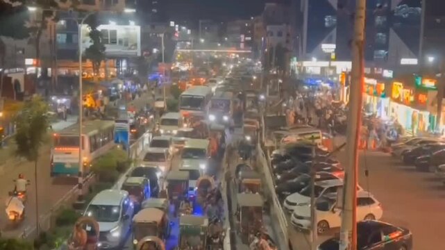 Busy City Traffic at Night with Cars, Buses and Auto Rickshaws