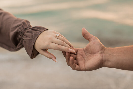 Man and woman holding hands after a proposal for their engagement 