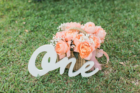 Beautiful Pink Rose Basket with One Birthday Sign on the grass for First Birthday Party