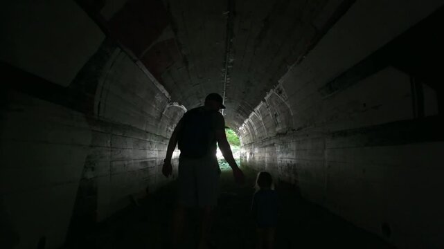 Langford, British Columbia, Canada - September 16, 2026: Silhouette of Father and Child Walking Through Historic Goldstream Park Concrete Tunnel