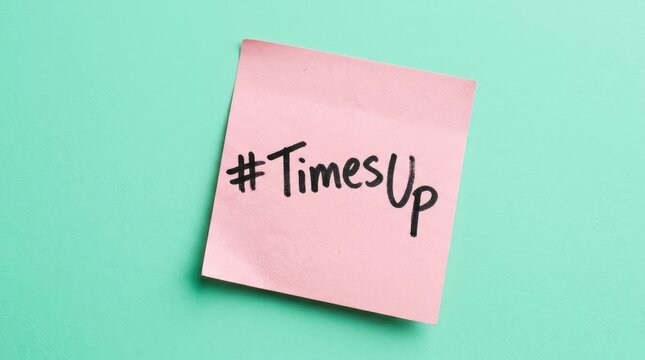 Pink sticky note with handwritten hashtag times up message isolated on a vibrant bright background