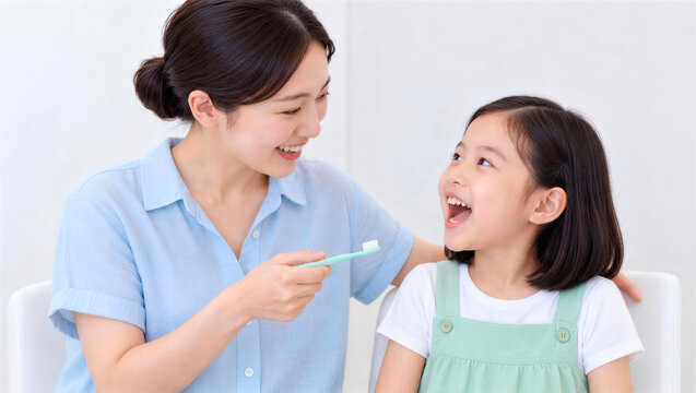 自宅で女の子の歯を仕上げ磨きする母親