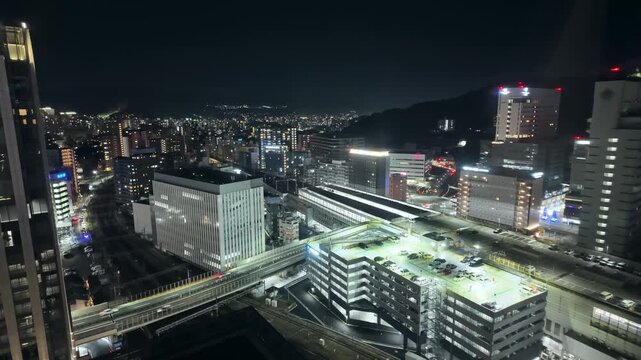 Nighttime aerial time-lapse of train station and road view
