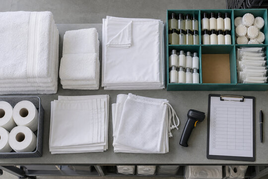 Hotel linen and amenity inventory check with restocking shortage viewed from above