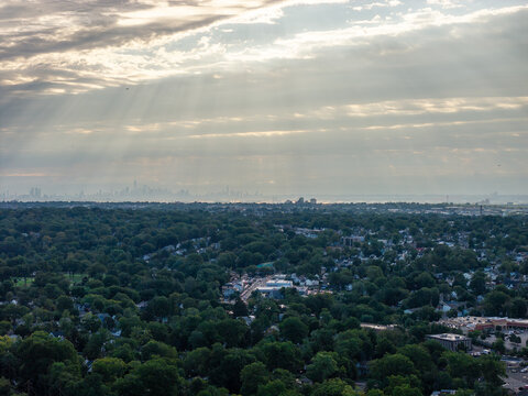Panoramic view showing a wide urban cityscape, layered architecture, streets, rooftops and skyline beneath daylight clouds in a detailed high-angle travel composition with clear visual depth acros
