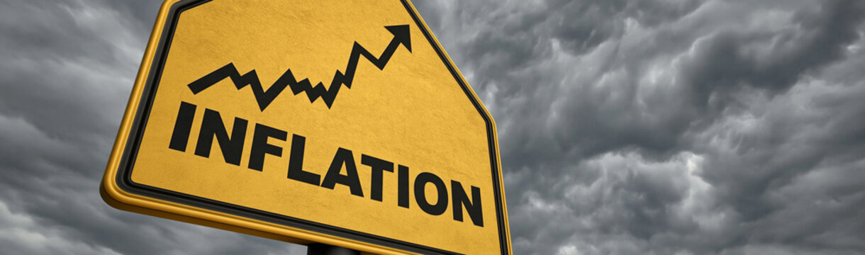 Rising Inflation Warning: A yellow warning sign with INFLATION written in bold black letters sits beneath a dark, stormy sky, symbolizing economic instability and rising costs.