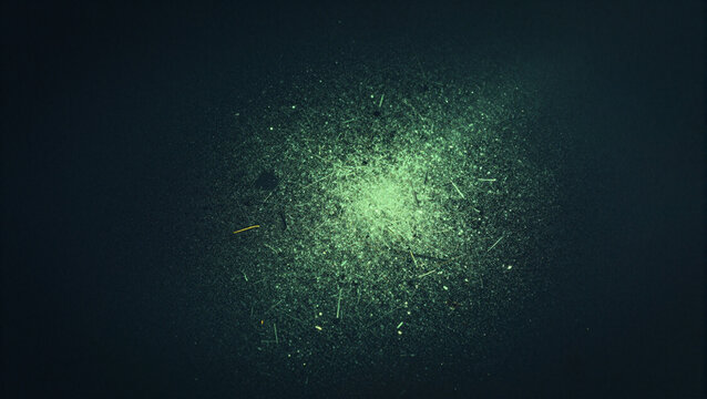 Eerie glowing green speckles floating in a dark moody void