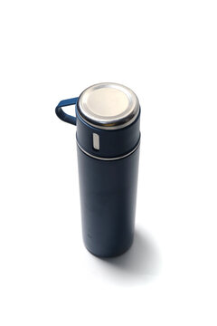 sleek navy blue stainless steel vacuum thermos bottle with a silver top cap and a side handle loop, isolated against a bright white background.