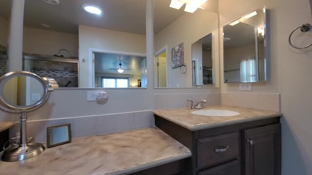 Contemporary bathroom vanity with marble countertop and large mirror