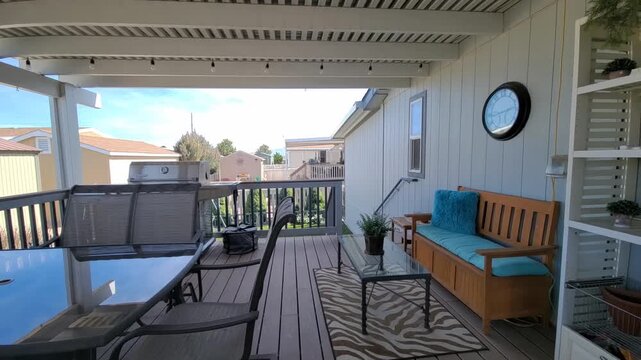 Cozy outdoor deck with blue cushions overlooking a suburban neighborhood