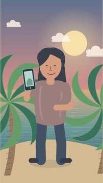 Femme filmant la mer avec son smartphone pr&egrave;s de palmiers tropicaux