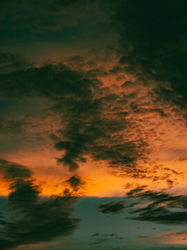 Intense Fiery Orange Sunset Clouds with Dark Brooding Storm Texture