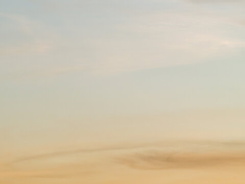Abstract Soft Blurred Sunset Sky in Muted Orange and Gray Tones