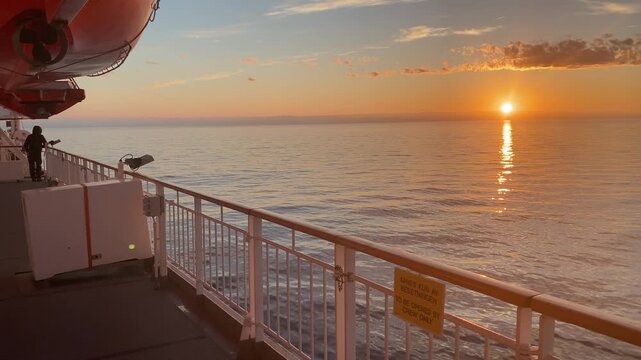 Hurtigruten ship sails across the Arctic Ocean in the glow of the midnight sun, tourism, transport, Arctic, Finnmark, Norway